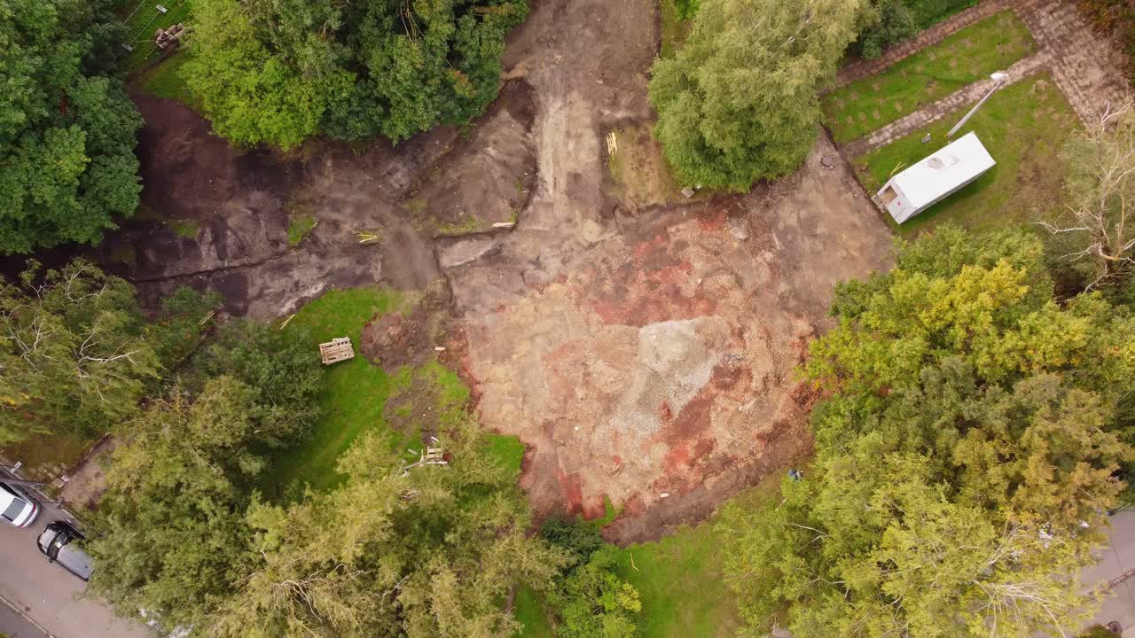 Muddy land ready for parking lot construction, aerial drone view