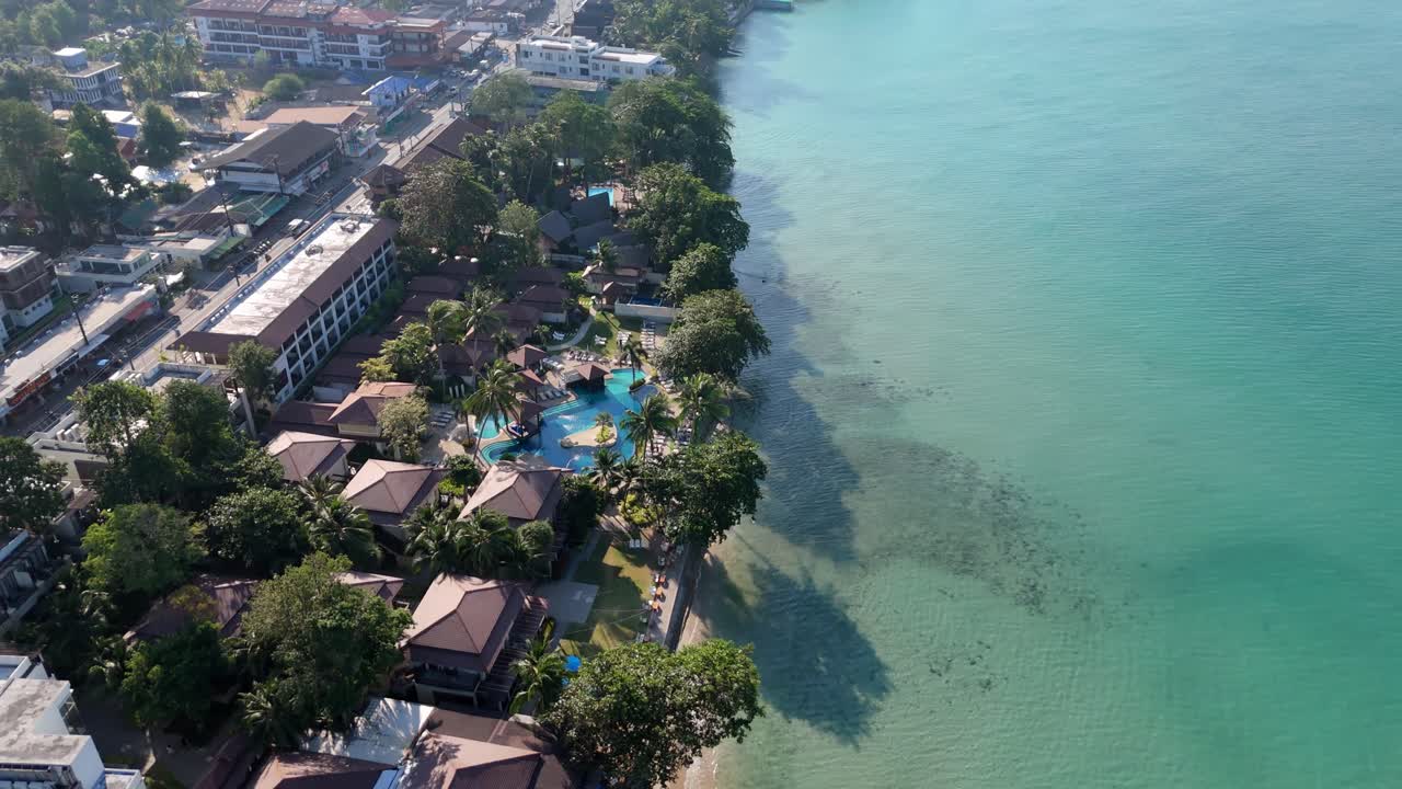 Aerial drone footage of White Sand Beach village, Koh Chang, Thailand. Capturing sunny morning views of the coast and tropical scenery