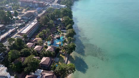 aerial drone footage of white sand beach village, koh chang, thailand. capturing sunny morning views of the coast and tropical scenery