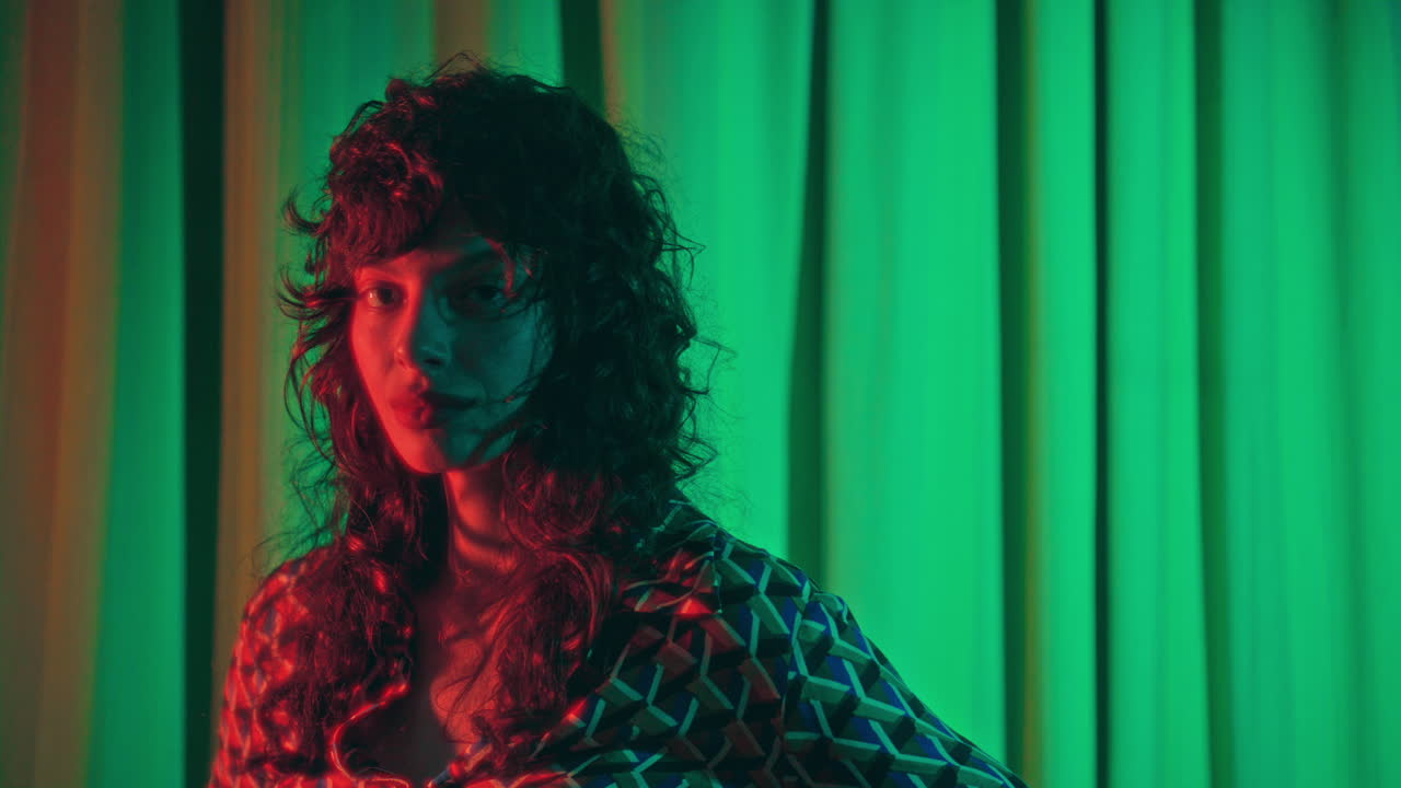 Portrait of Young Woman in Retro Outfit under Colorful Cinematic Light