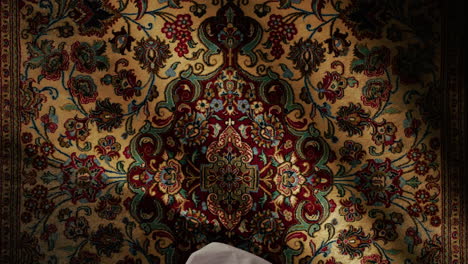 man praying on carpet for ramadan culture
