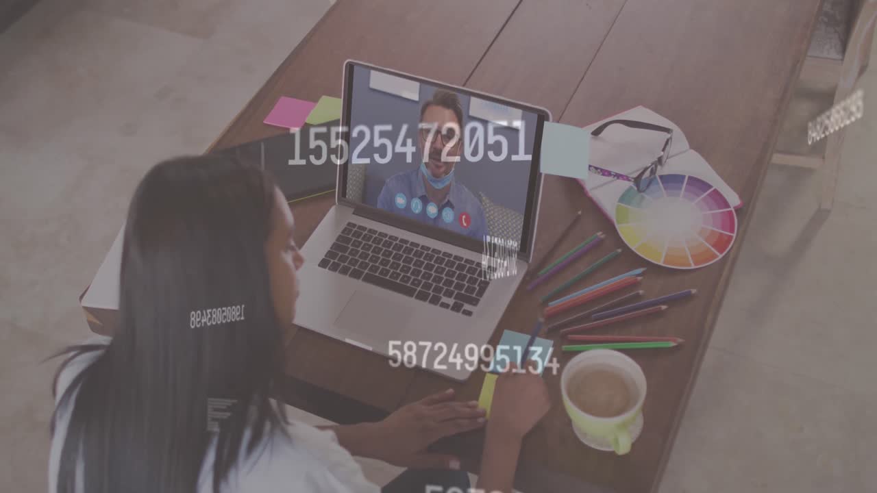 Multiple changing numbers against woman having a video call with male colleague on laptop at office