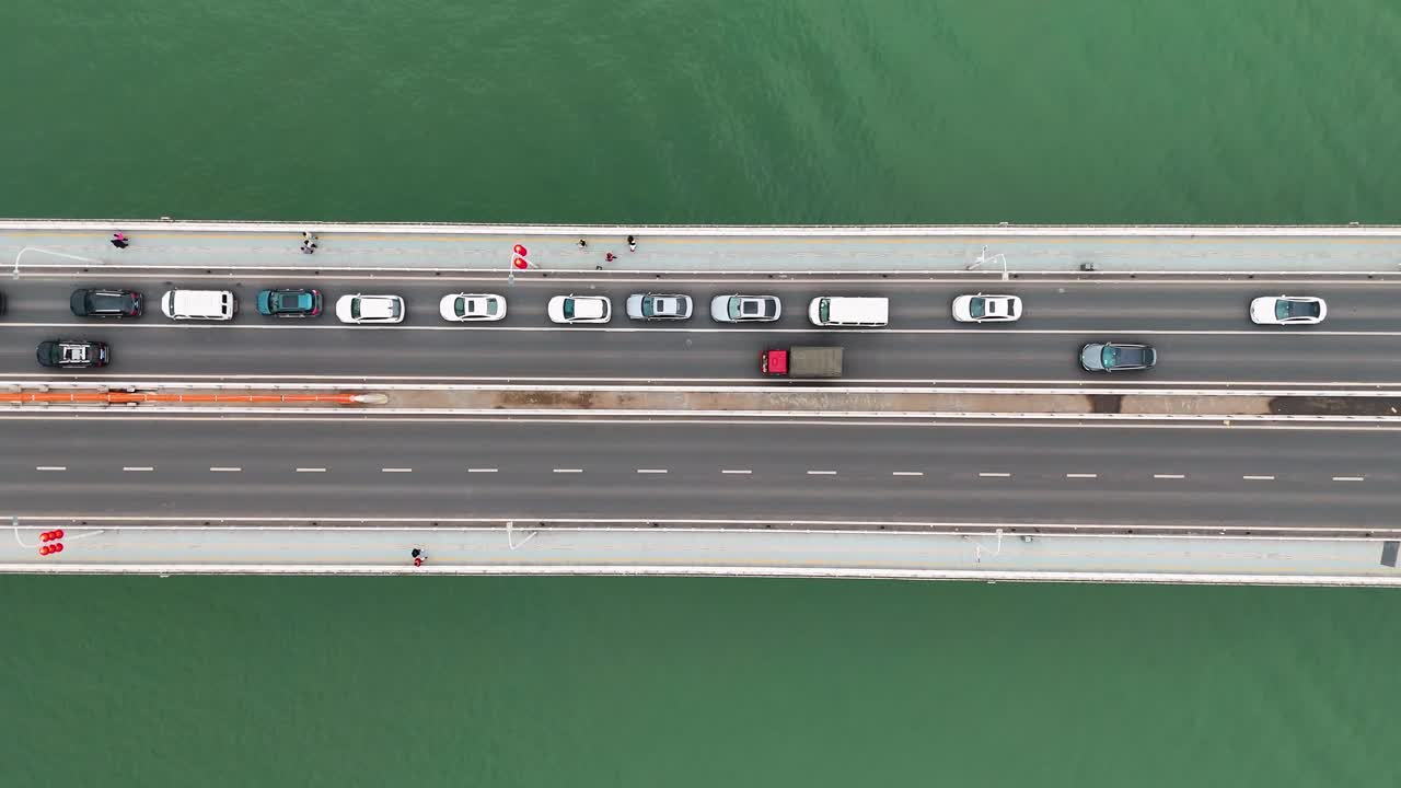 Aerial view of the Dongshuimen Bridge in Chongqing, China, with traffic flowing across multiple lanes. A snapshot of urban connectivity, showcasing infrastructure and the dynamic city life.
