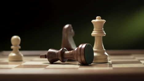 hand moving chess figure in competition with blurred background