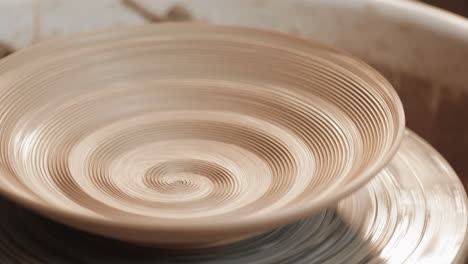 making a bowl on a pottery wheel