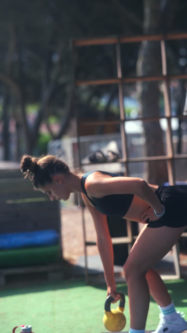 Woman doing kettlebell workout outdoors