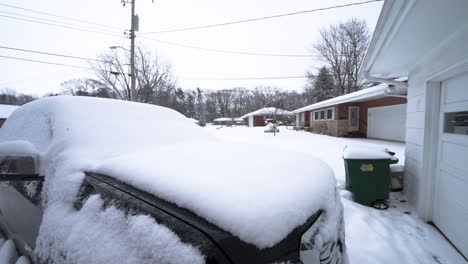 Rising-motion-over-the-front-passenger-corner-of-a-2016-GMC-Canyon-covered-in-fresh-snow