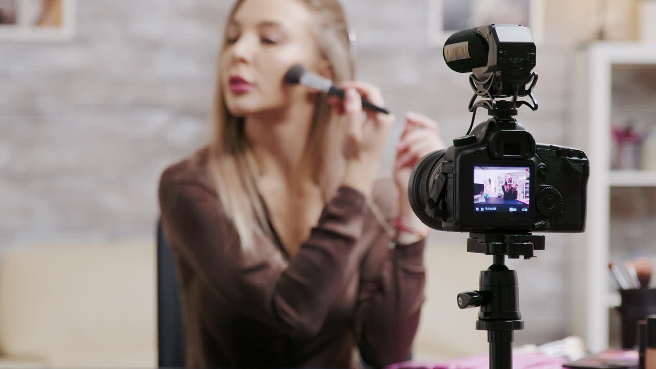 Woman recording makeup tutorial for vlog