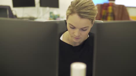 A-blonde-female-employee-is-checking-her-phone