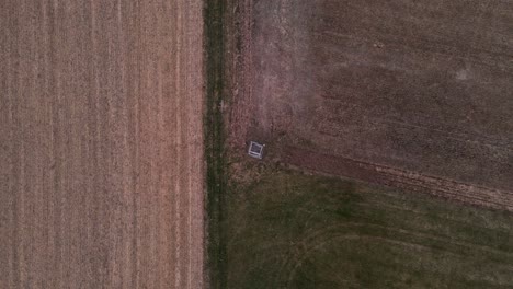 a hunter's deer stand in the middle of green and brown fields in germany