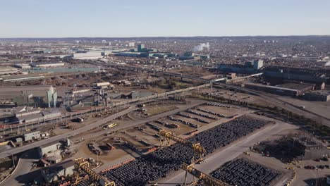 Hamilton,-ontario-showcasing-industrial-landscape-with-rows-of-parked-vehicles,-aerial-view