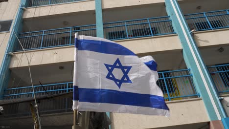 an israeli blue and white star of david flag mounted on a humvee in gaza