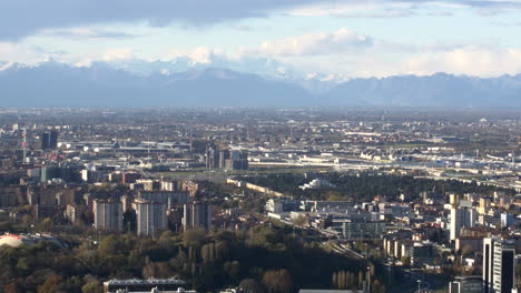 snowy peaks of alps and milan city bellow, aerial view