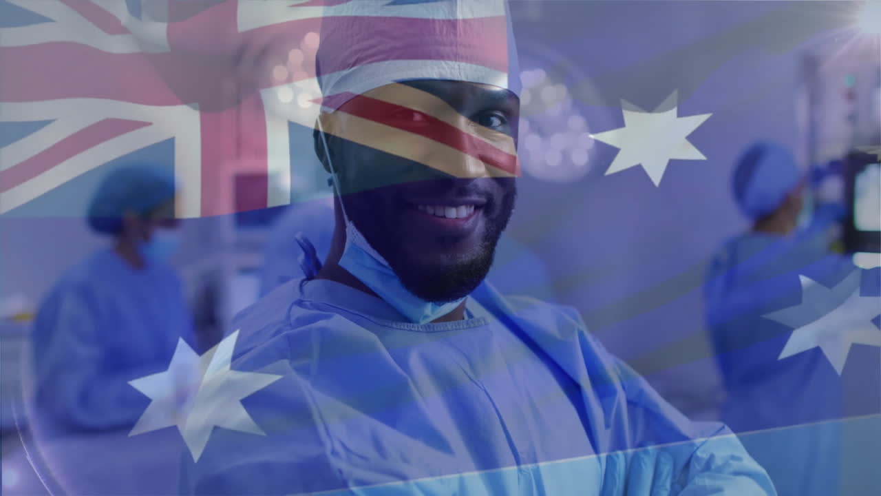 Animation of flag of australia over african american male surgeon in hospital