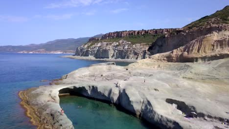 drone aerial shot of the natural swimming pool of cane malu in sardinia, italy. a wonderful typical mediterranean coastal landscape