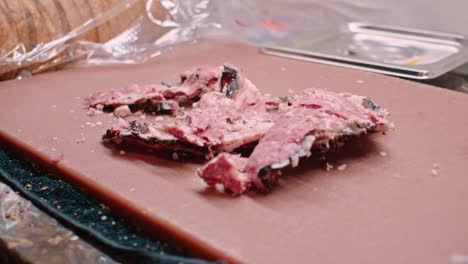 hands in white gloves preparing pastrami meat for sandwich, close up