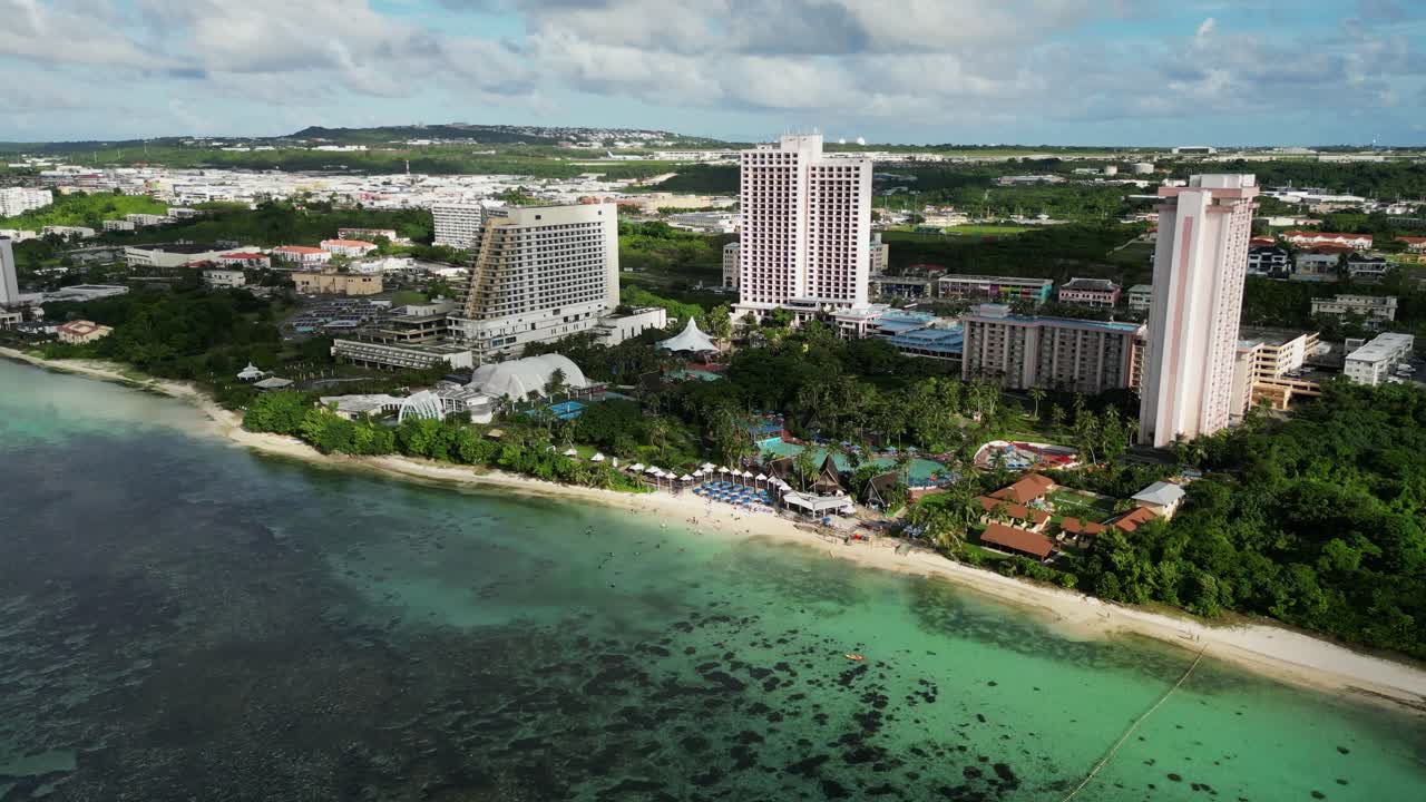 Picturesque aerial drone shot of Pacific Islands Club Hotel Resort and idyllic beach coastline with turquoise waters at Guam, USA