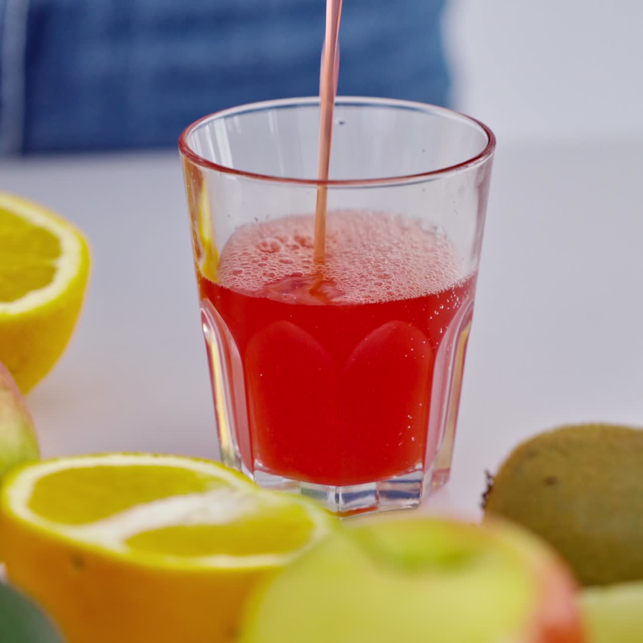 Woman preparing juice in the kitchen