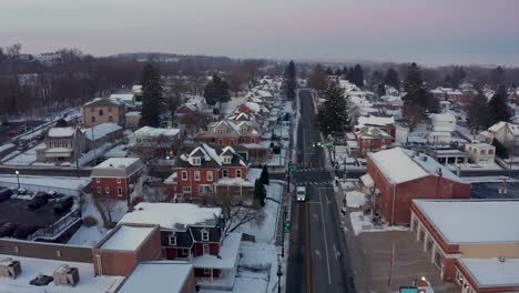 aerial establishing shot of american small town covered in winter snow