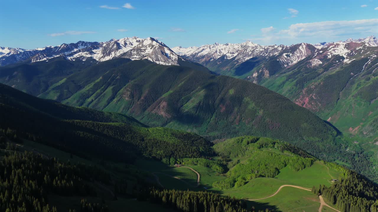 Conundrum creek trail Aspen Mountain Ajax Little Annie Trail 4wd road aerial drone Colorado Castle Peak 14er Rocky Mountains Elk Range Aspen Trees spring summer morning blue sky clouds forward pan up