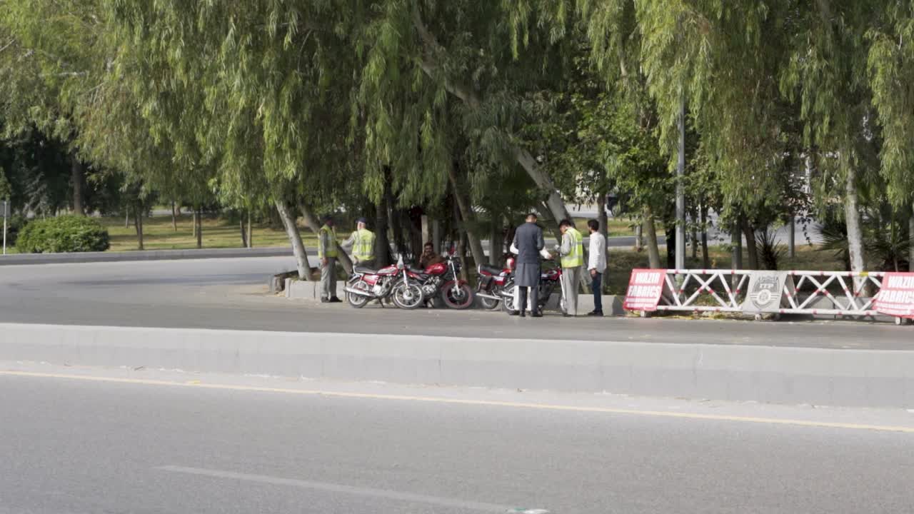 Traffic police are currently on the road, questioning a few bike riders.