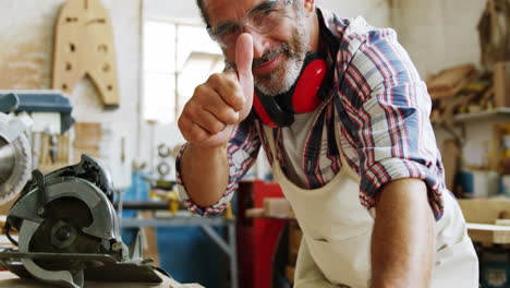 Happy-carpenter-with-thumbs-up-while-working