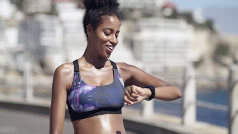 woman checking fitness watch during outdoor workout
