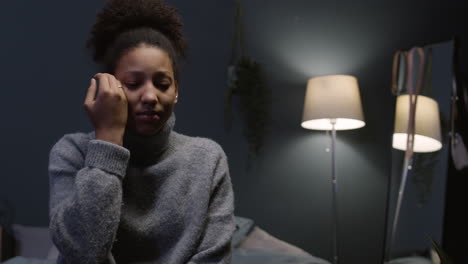 young woman crying on her bedroom