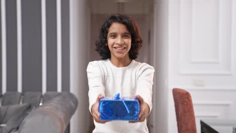 Cute-Indian-kid-boy-offering-gift-to-the-camera