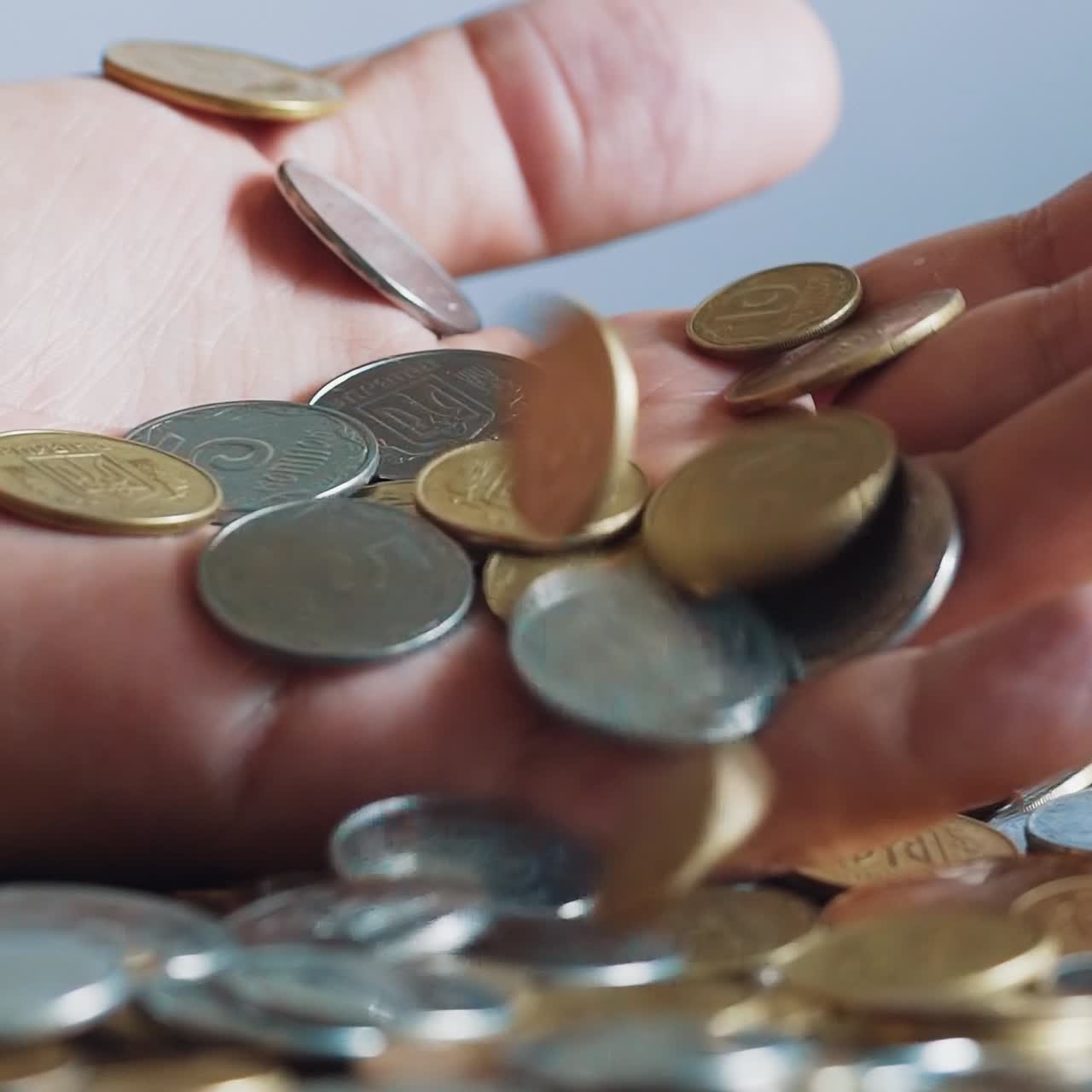 Man is holding coins in his hands. Man's hands hold a lot of gold coins. Financial, business concept.