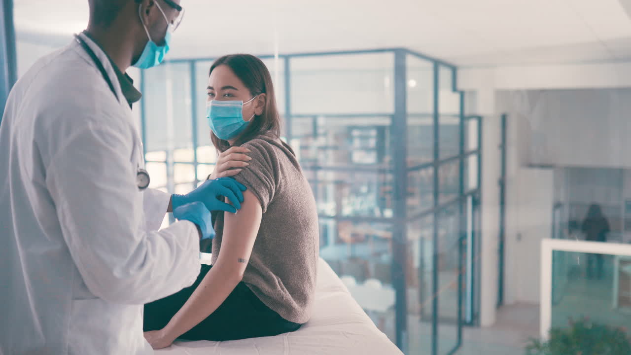Doctor administering a vaccine to a patient