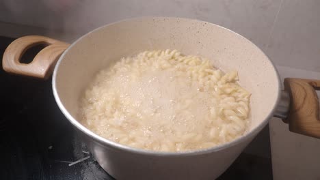 boiling pasta in a pot