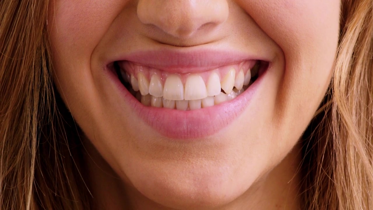 Close-up of a Young Woman Smiling Broadly