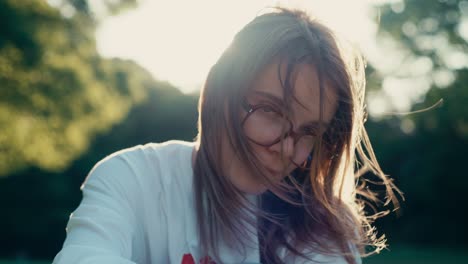 natural beauty and emotion in sunny backlit portrait at park.