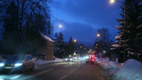 police car chasing drunk driver on street at night, dashboard view