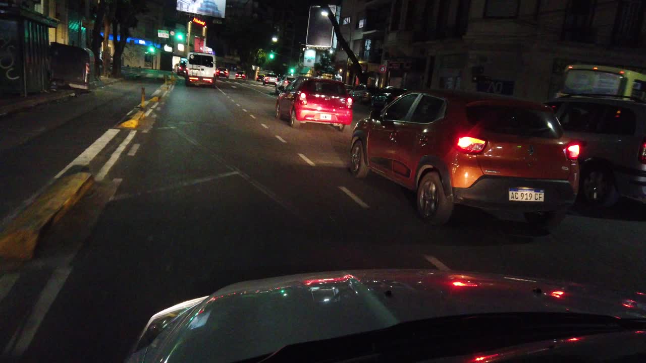 Driver's POV driving at night in city downtown