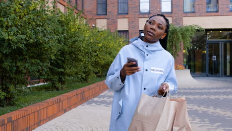 Young-woman-holding-paper-bags-on-the-street