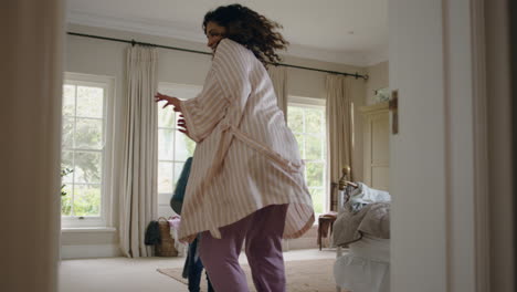 happy little boy chasing mother with watering can playing catch running through house mom enjoying fun game with child enjoying weekend morning together 4k footage