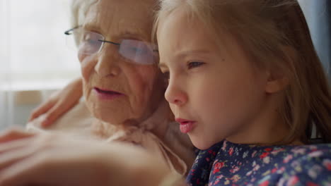 girl reading book with grandma