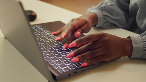 woman typing information on laptop