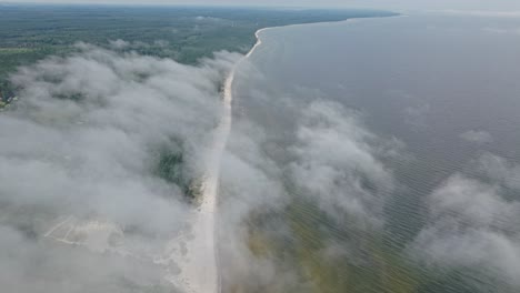 cloud sea fog formations drifting over remote coastline sky aerial