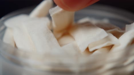 snus nicotine tobacco close up, pack of tobacco for gum. unhealthy addiction. man opening box with snus and taking one.