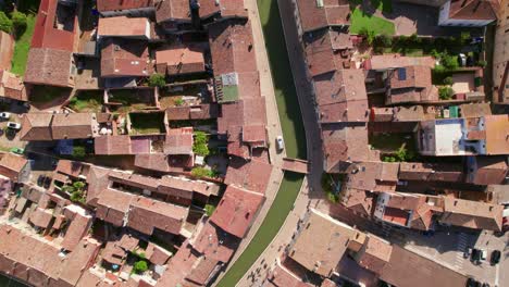 Comacchio,-Italy,-drone-top-down-view-of-urban-infrastructure,-city's-canal,-little-Italian-city,-sunny-weather