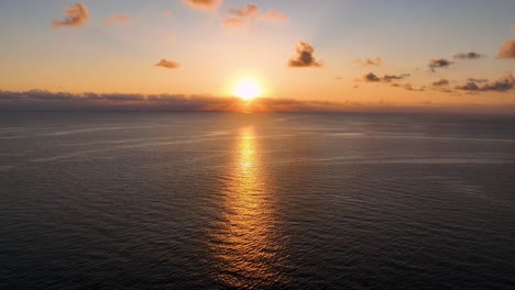 amazing orange sunrise over calm sea filmed by drone