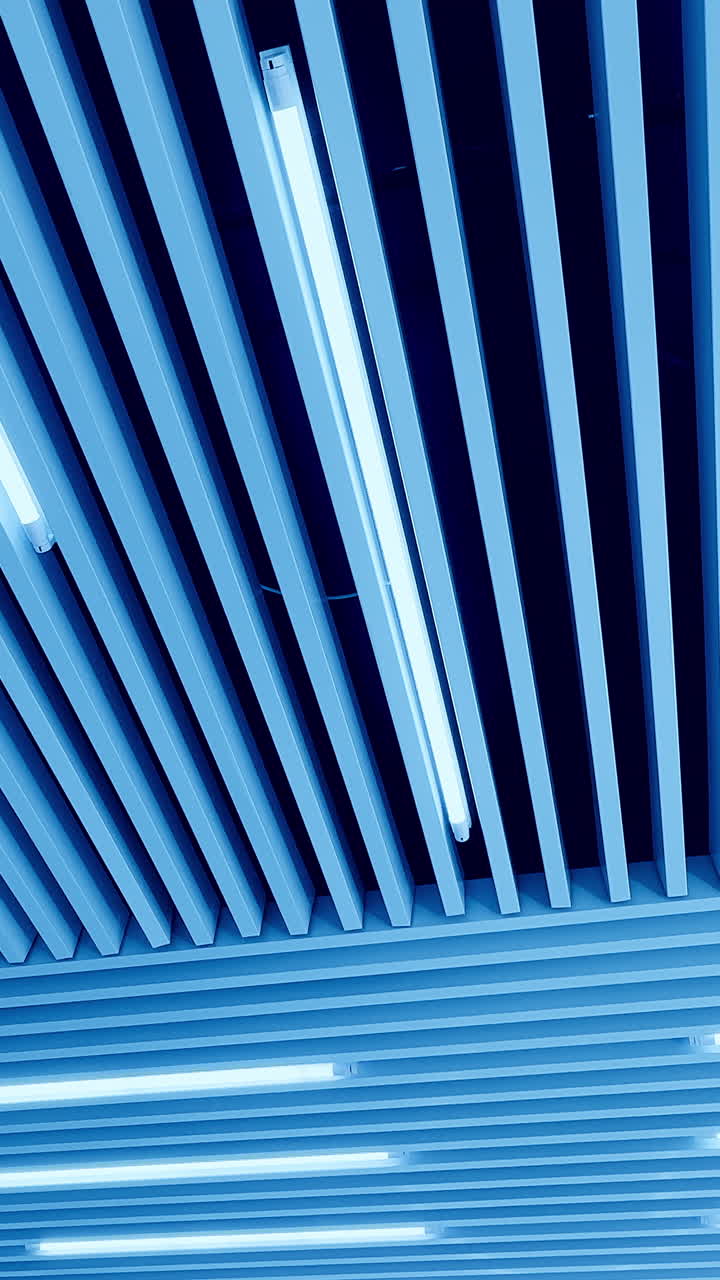 Embossed plank ceiling with bright illumination. Led lamps of day light from low angle perspective. Vertical video