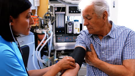 Female-doctor-checking-blood-pressure-of-patient