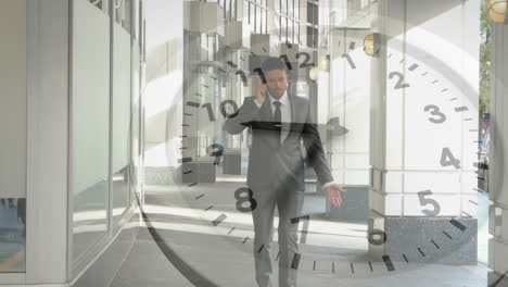 animation of clock with fast moving hands over caucasian businessman walking, talking on smartphone