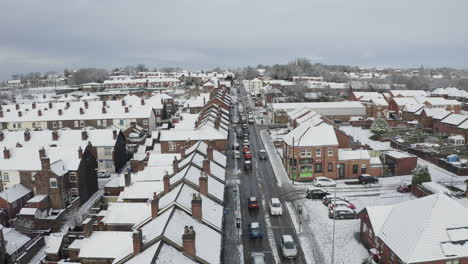 aerial view heavy traffic on anchor road longton, a sudden snow blizzard in stoke on trent, dangerous driving conditions, cars travelling slowly, safely, west midlands