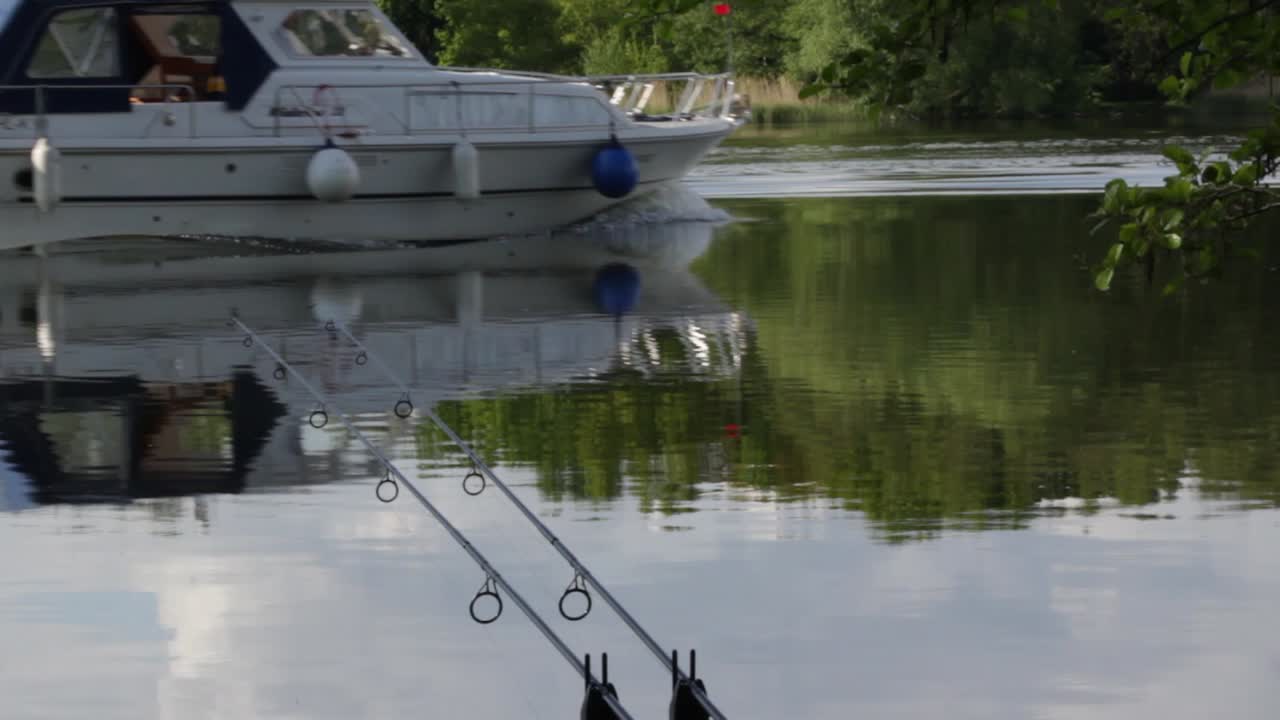 Fishing rod´s at a lake with boat in the backround