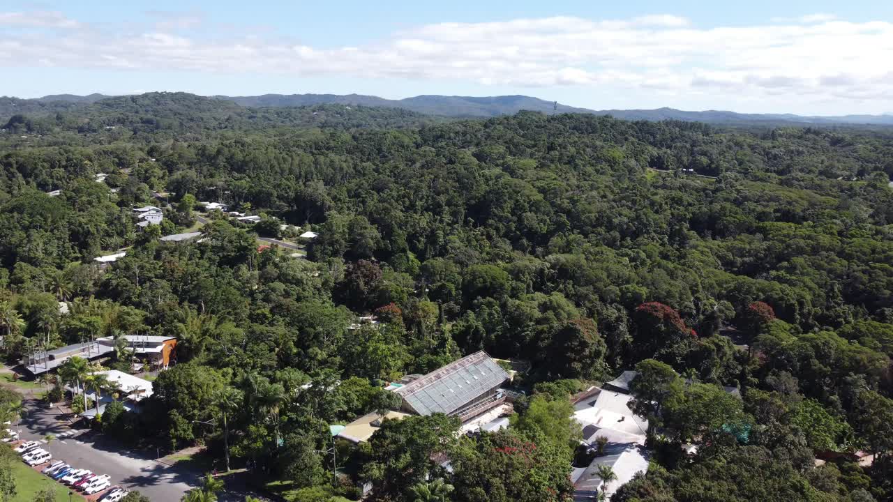 Drone Descending over a tropical rainforest in to a small mountain village in North Queensland, Australia